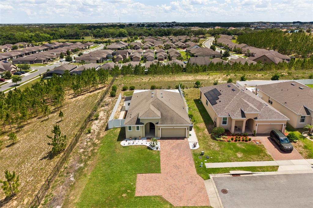An aerial view shows two suburban houses with paved driveways and surrounding residential neighborhoods — 268 JYOTI DRIVE, DAVENPORT, FL