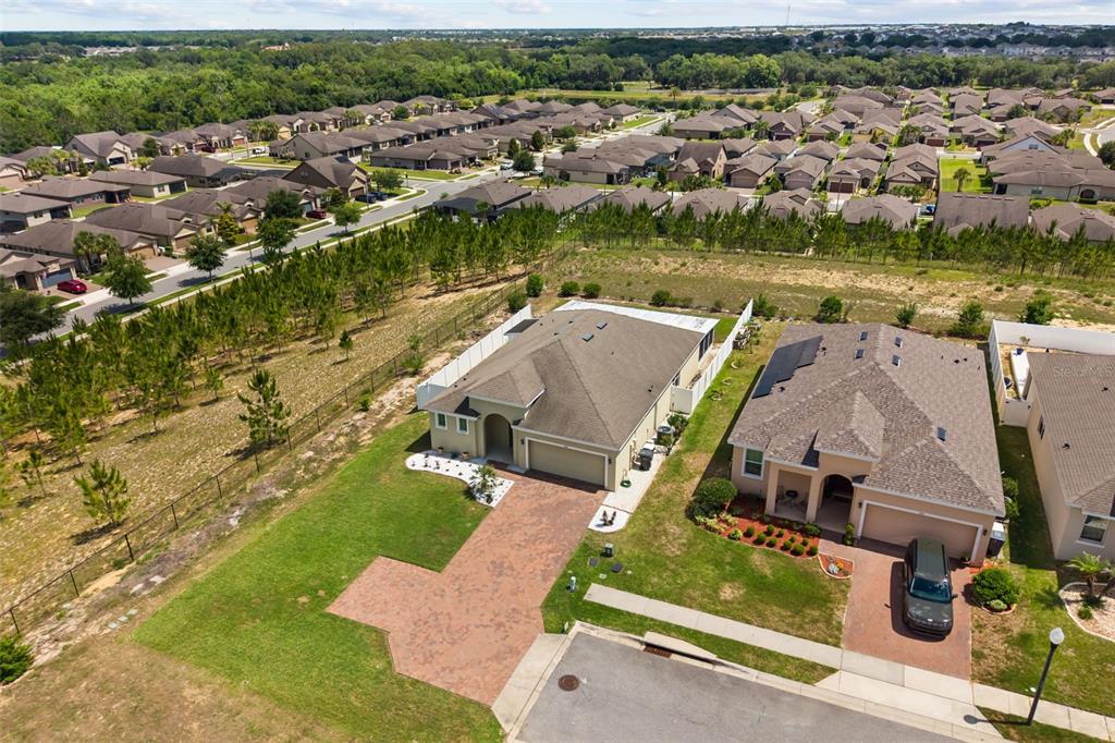 An aerial view shows two suburban houses with paved driveways and fenced backyards — 268 JYOTI DRIVE, DAVENPORT, FL