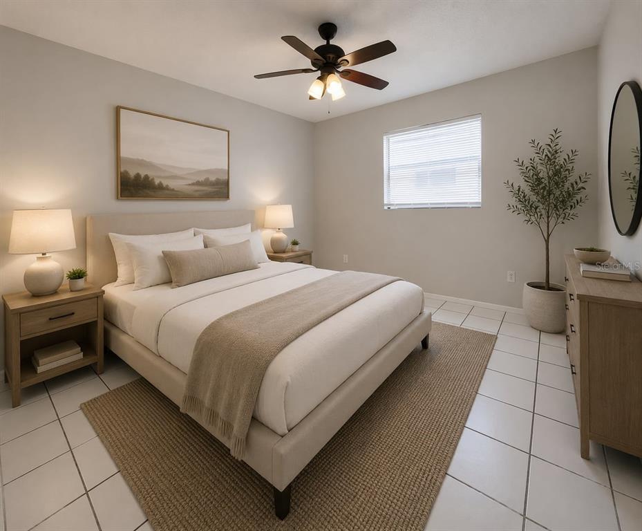 A bedroom with a bed, two nightstands, a dresser, a ceiling fan, and tile flooring — 5723 SILVER SPUR DRIVE, HOLIDAY, FL