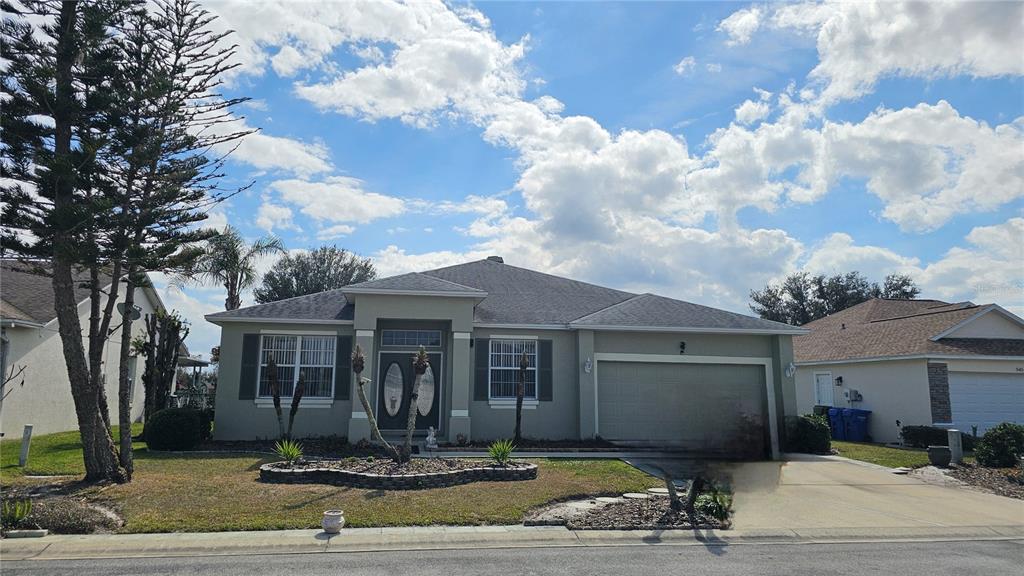 A single-story suburban house with a two-car garage and a landscaped front yard — 543 TERRANOVA CIRCLE, WINTER HAVEN, FL