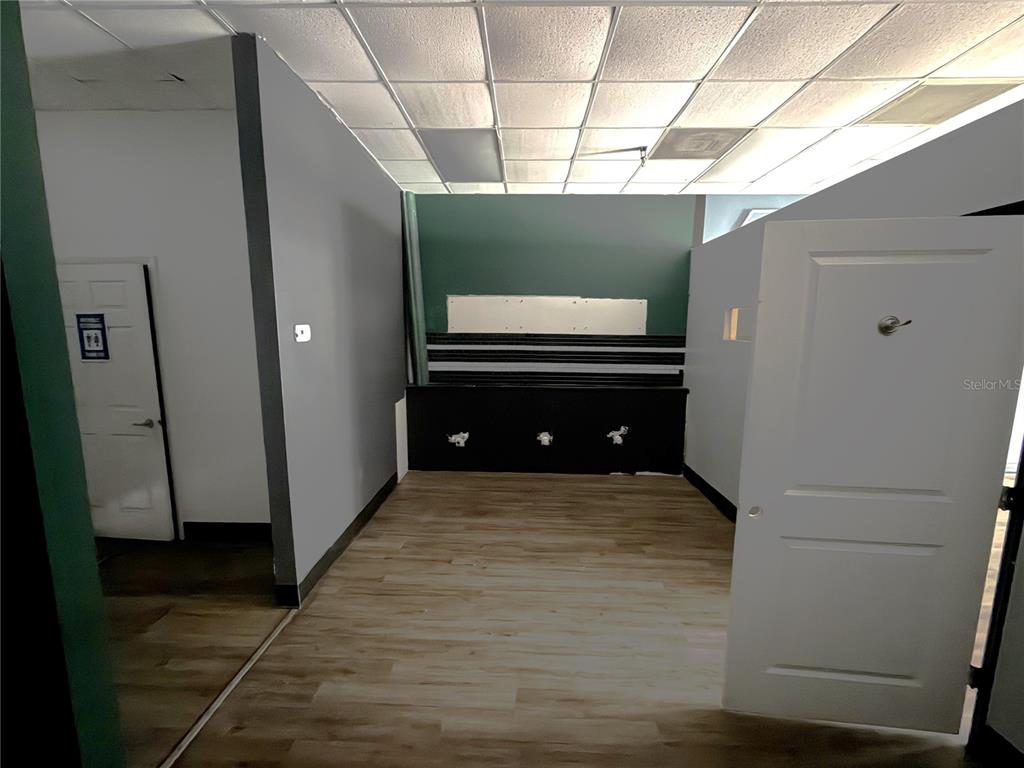 An interior room features light wood-look flooring, gray walls, and a black accent wall section — 226 ST. JOE PLAZA DRIVE, PALM COAST, FL
