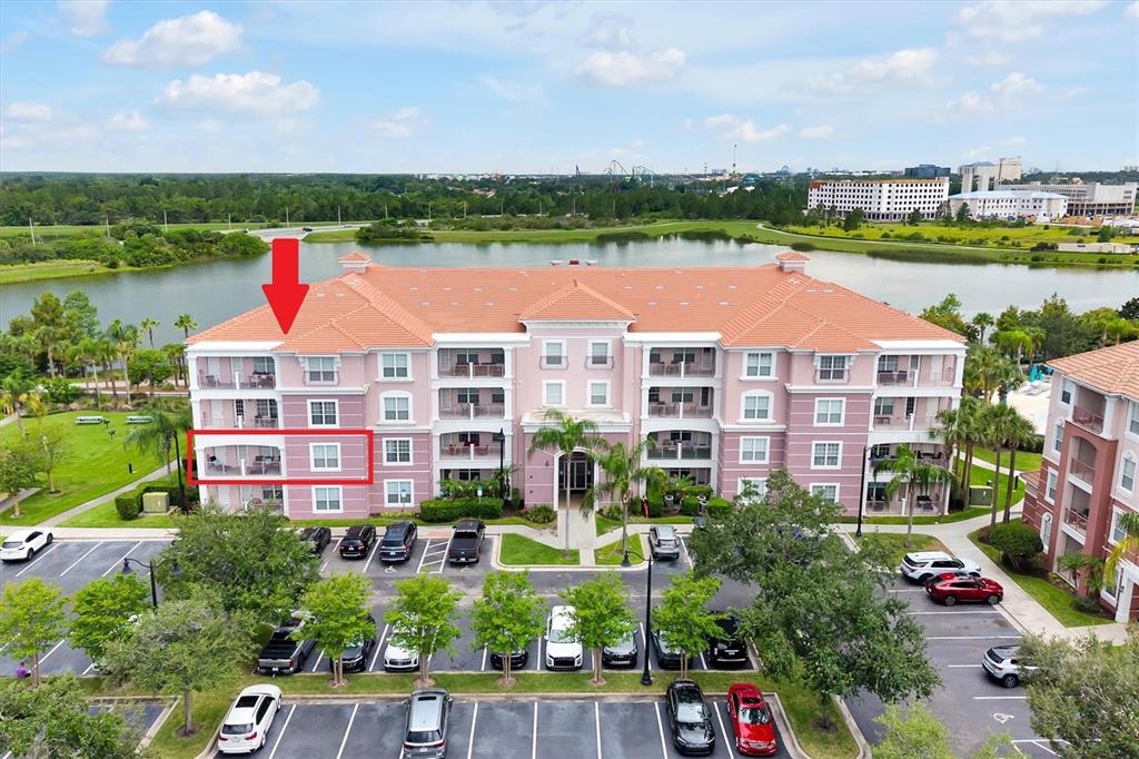 An aerial view shows a multi-story apartment building with a red tile roof — 4840 CAYVIEW AVENUE UNIT 20310, ORLANDO, FL