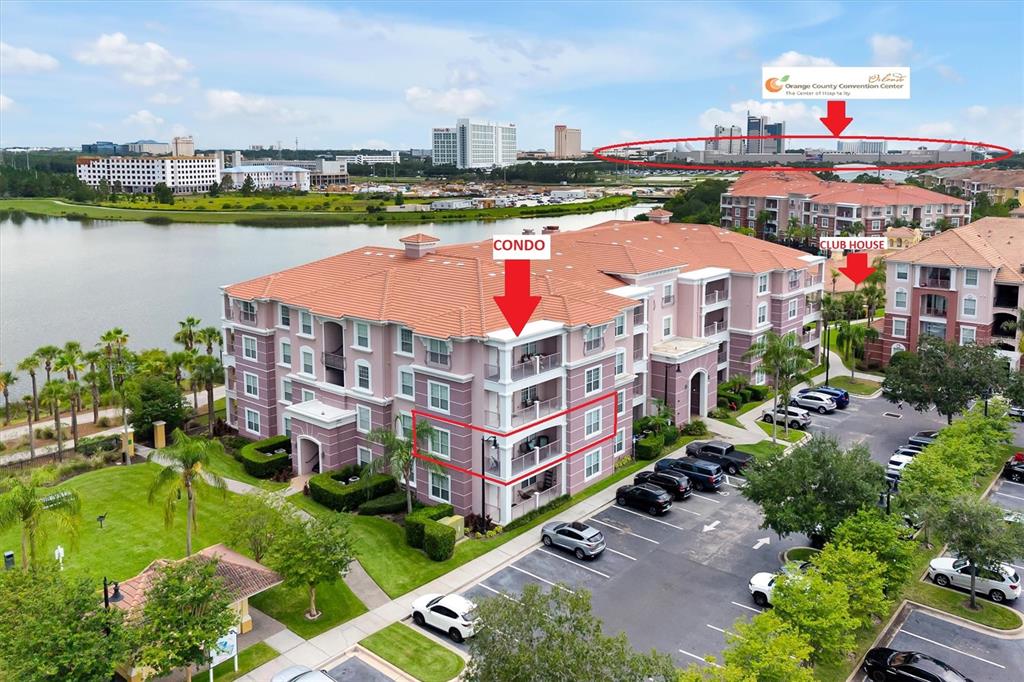 An aerial view shows a multi-story residential building with a lake and parking lot — 4840 CAYVIEW AVENUE UNIT 20310, ORLANDO, FL