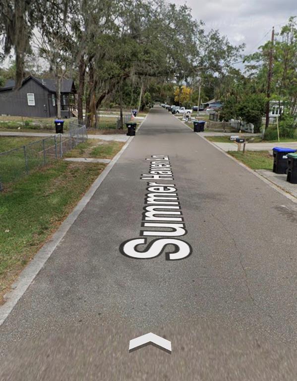 A paved residential street named Summer Haven Ln is lined with houses and trash bins — 3788 SUMMER HAVEN LANE, APOPKA, FL