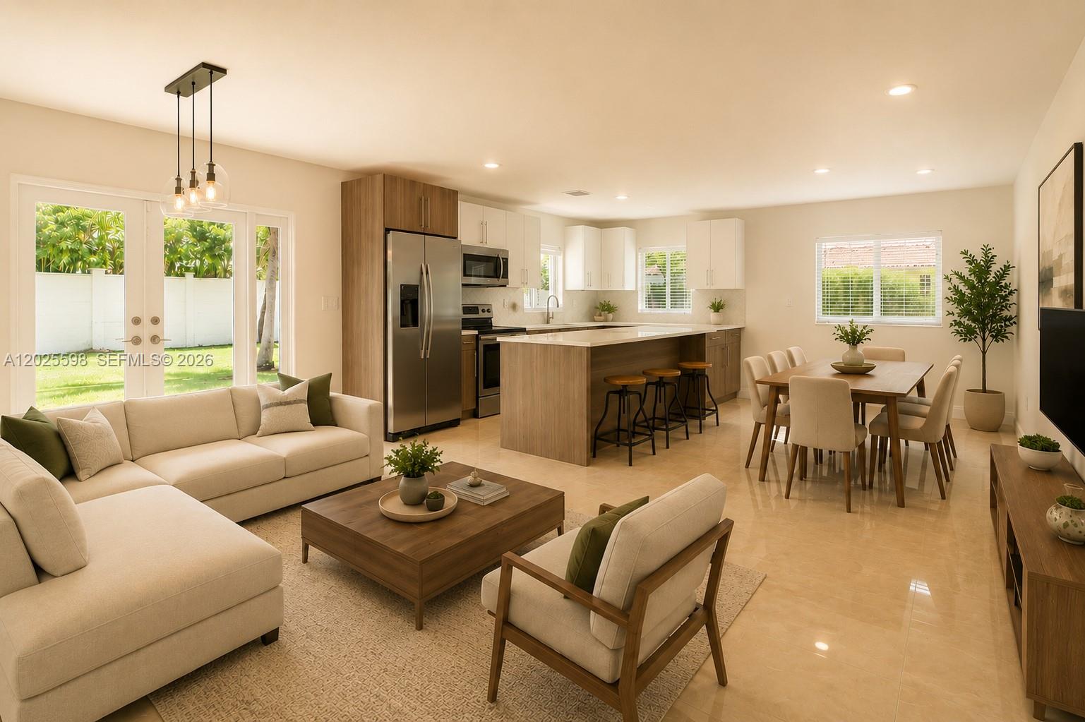An open-concept living area features a kitchen with an island, dining space, and modern furniture — 9421 SW 150th St, Miami FL 33176, MIAMI, FL