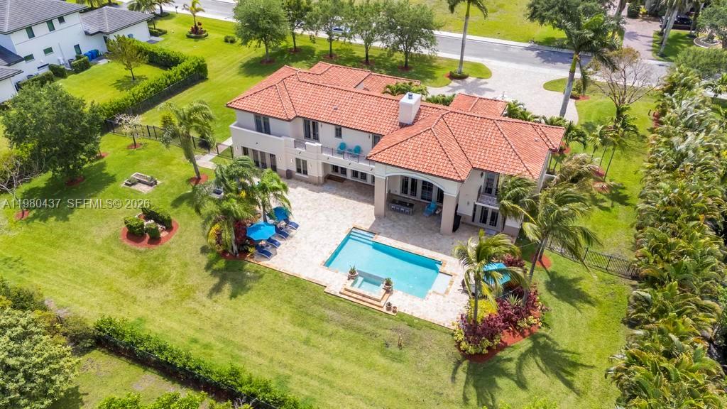 An aerial view of a two-story house with a red tile roof and swimming pool — 13425 SW 37th Pl, Davie FL 33330, DAVIE, FL