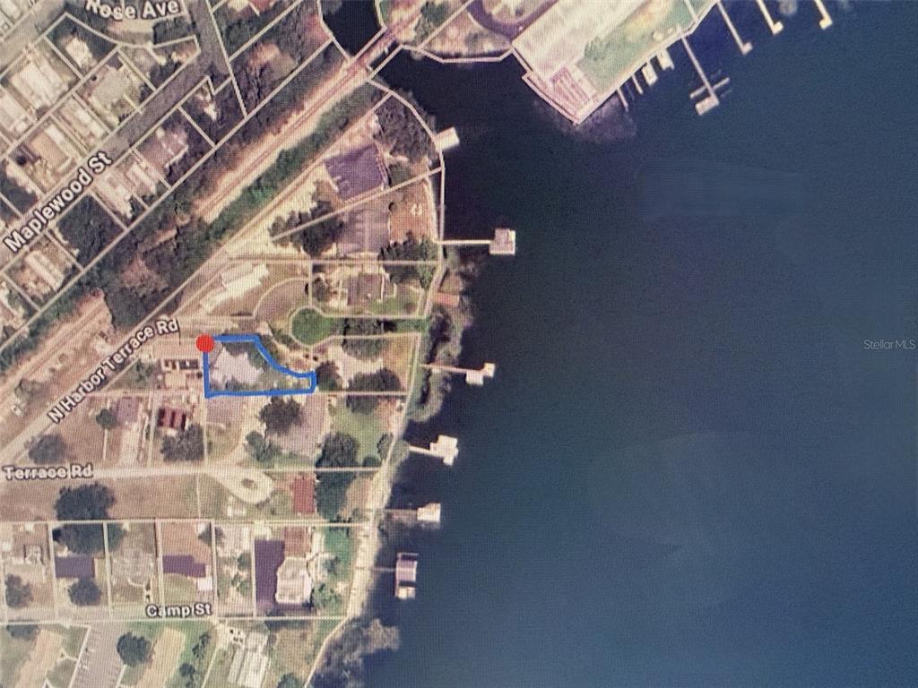 An aerial map view shows a residential property outlined in blue along a waterfront — 903 N HARBOR TERRACE, TAVARES, FL