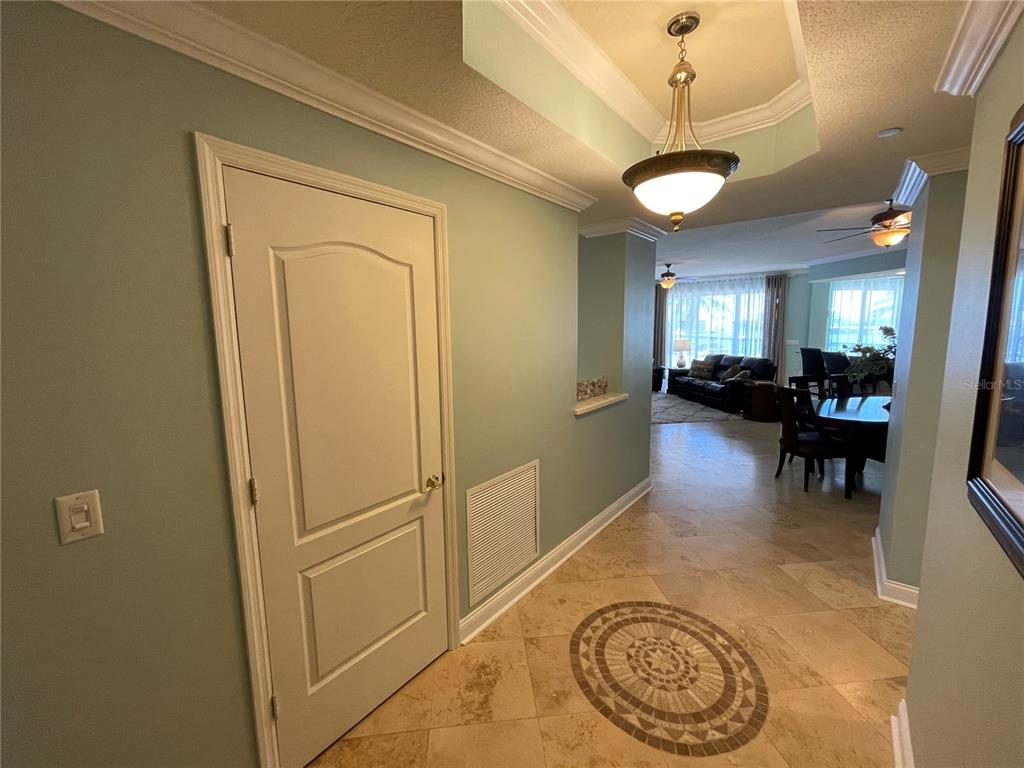 A tiled entryway leads into a living and dining area with light green walls — 521 MANDALAY AVENUE UNIT 309, CLEARWATER BEACH, FL