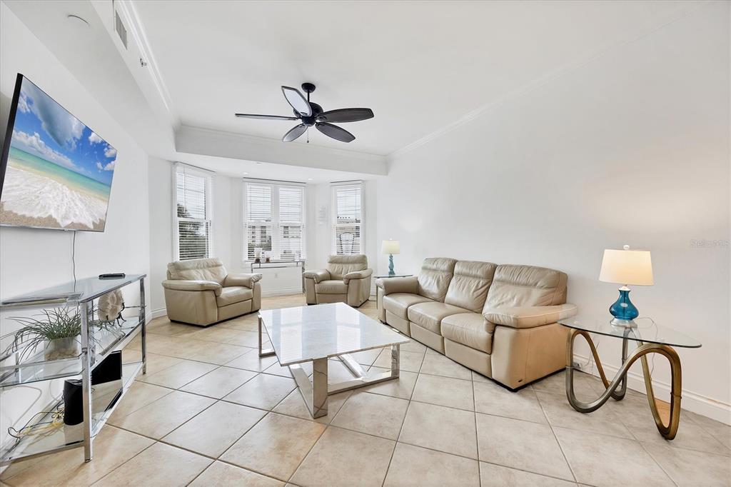 A living room features beige leather furniture, a marble coffee table, and light tile flooring — 8111 LAKEWOOD MAIN STREET UNIT 304, LAKEWOOD RANCH, FL