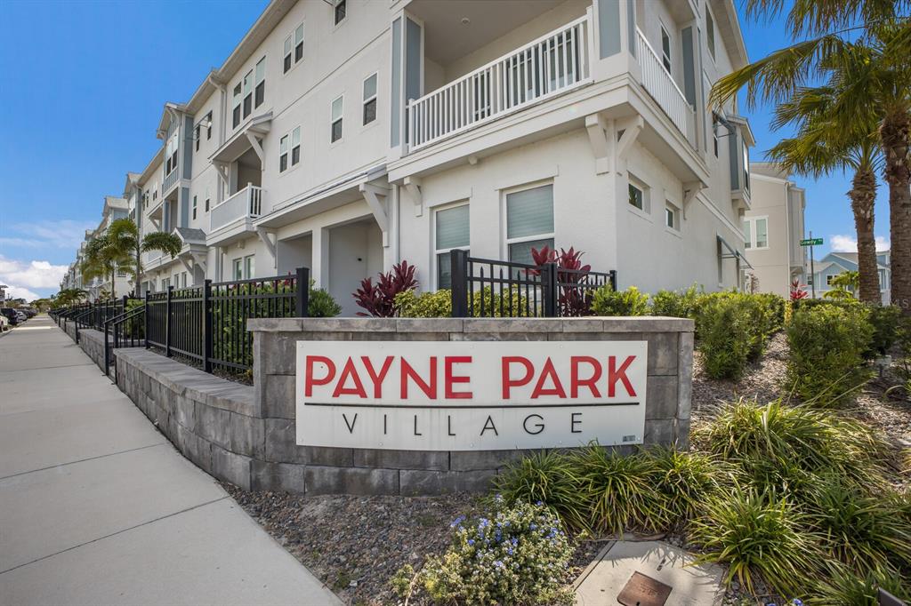 An aerial view of a multi-story townhouse complex with light-colored siding and gray roofs — 2467 MANGUM COURT, SARASOTA, FL