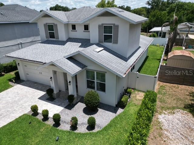 An aerial view shows the exterior of a two-story house with a gray shingled roof — 3875 S FERN CREEK AVENUE, ORLANDO, FL