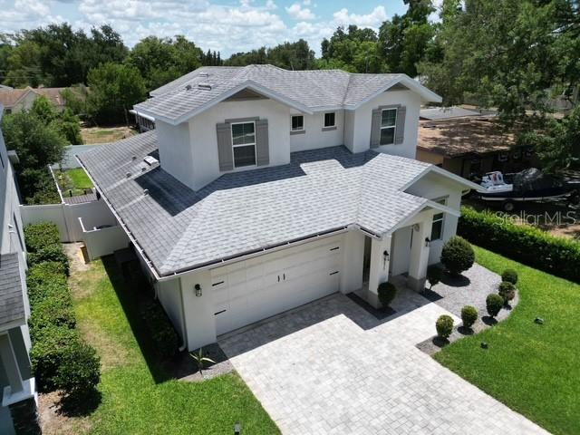 An aerial view shows a two-story house with a gray roof and a paved driveway — 3875 S FERN CREEK AVENUE, ORLANDO, FL