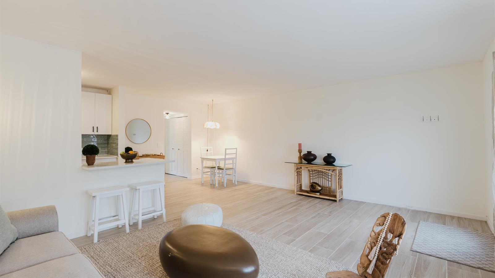 A bright, open-concept living and dining area features light wood-look tile flooring and white walls — 272 Preston G Way, Boca Raton FL 33434, BOCA RATON, FL