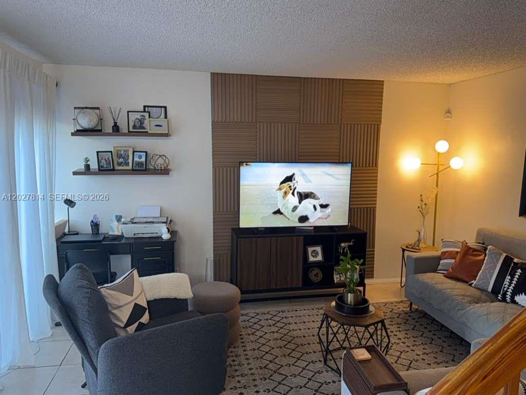 A living room features a slatted wood accent wall, a television, and a desk area — 3473 SW 52nd Ave, Pembroke Pines FL 33023, PEMBROKE PINES, FL