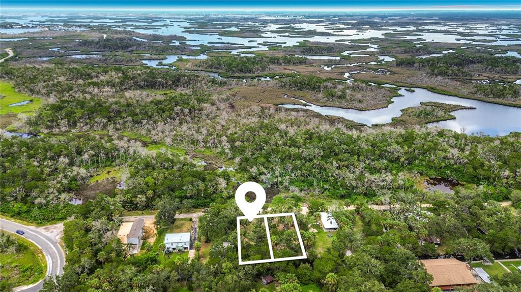 An aerial view shows a wooded residential area with a highlighted plot of land — 14334 W SUTTON COURT, CRYSTAL RIVER, FL