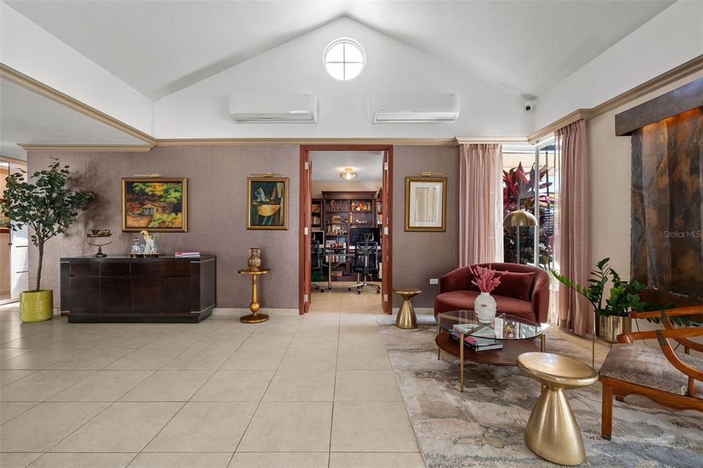 A living area features vaulted ceilings, tile floors, a central doorway, and a seating area — 377 CORREDOR DE LA ARBOLEDA, DORADO, PR