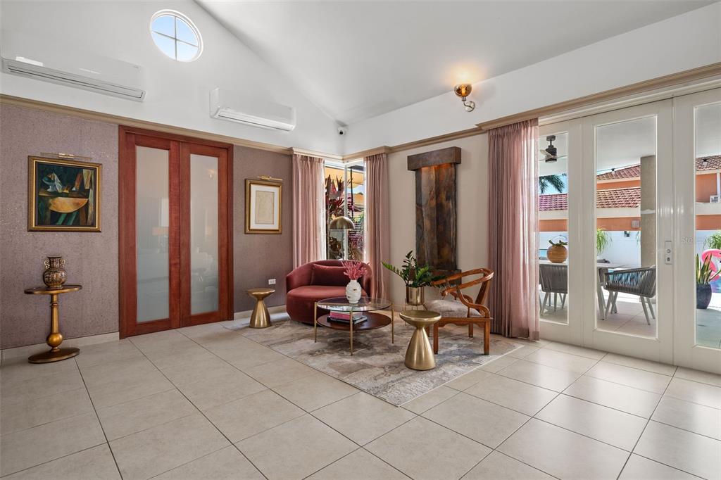 A living room features tile floors, a vaulted ceiling, a water feature, and glass doors — 377 CORREDOR DE LA ARBOLEDA, DORADO, PR