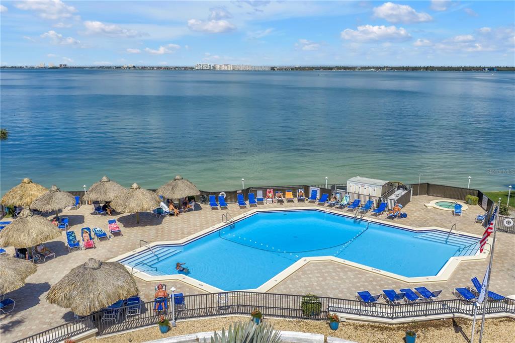 An aerial view shows a waterfront condominium complex with a red arrow pointing to a unit — 5825 PUERTA DEL SOL BOULEVARD S UNIT 464, ST PETERSBURG, FL