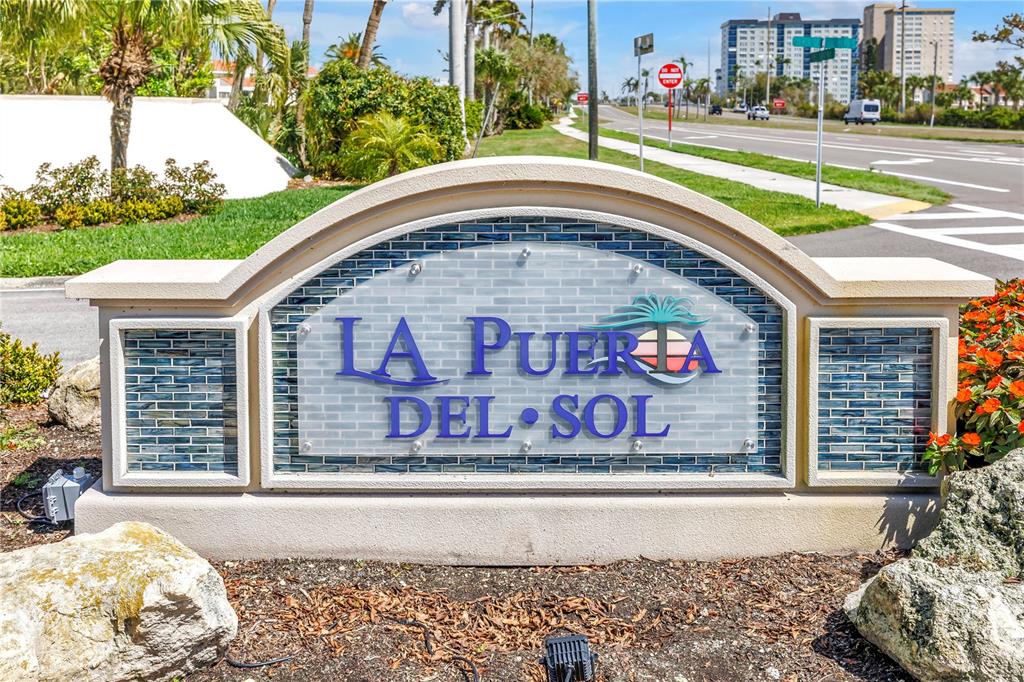 An aerial view shows a waterfront apartment complex with a golf course and marina — 5825 PUERTA DEL SOL BOULEVARD S UNIT 464, ST PETERSBURG, FL