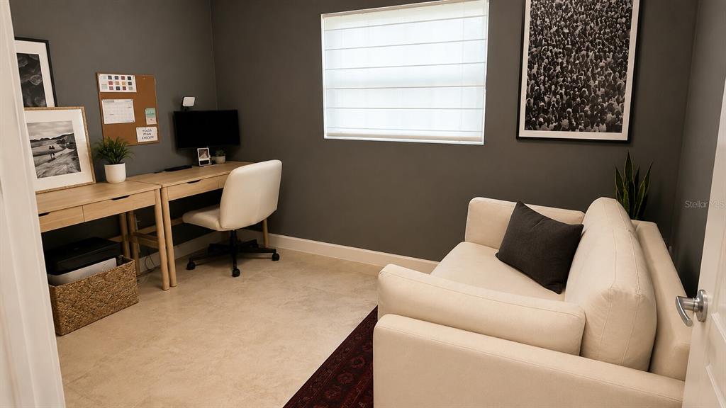 A home office features a desk, a white sofa, and dark gray walls — 150 W 11TH STREET, CHULUOTA, FL