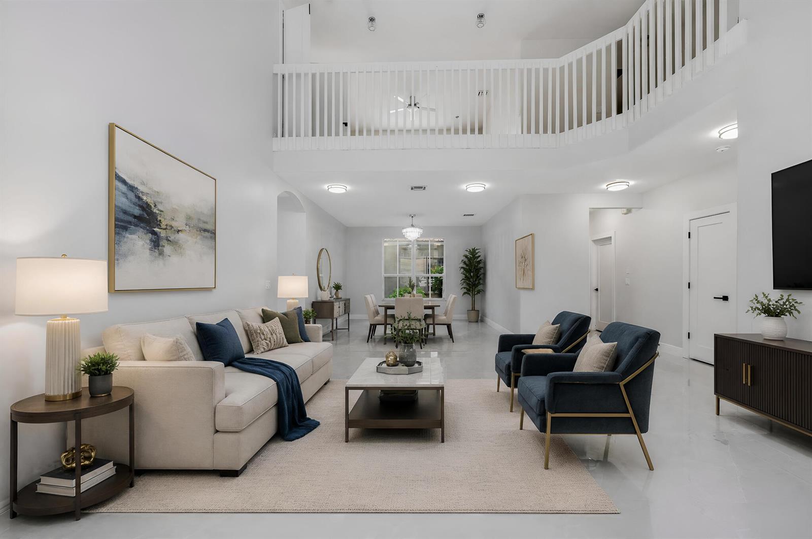 A bright, open-concept living and dining area features white walls, high ceilings, and modern furniture — 12197 Colony Preserve Drive, Boynton Beach FL 33436, BOYNTON BEACH, FL