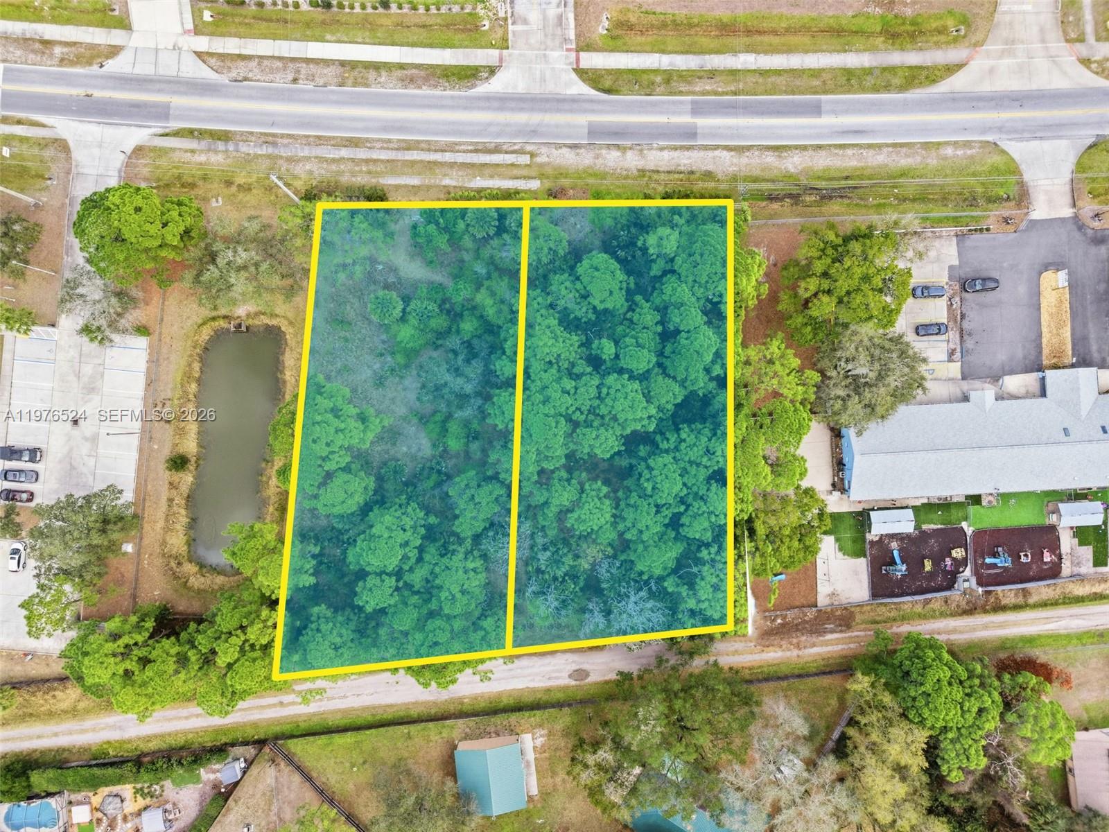 An aerial view shows two adjacent, wooded rectangular lots outlined in yellow — 820 Jupiter Blvd NW, Palm Bay FL 32907, PALM BAY, FL