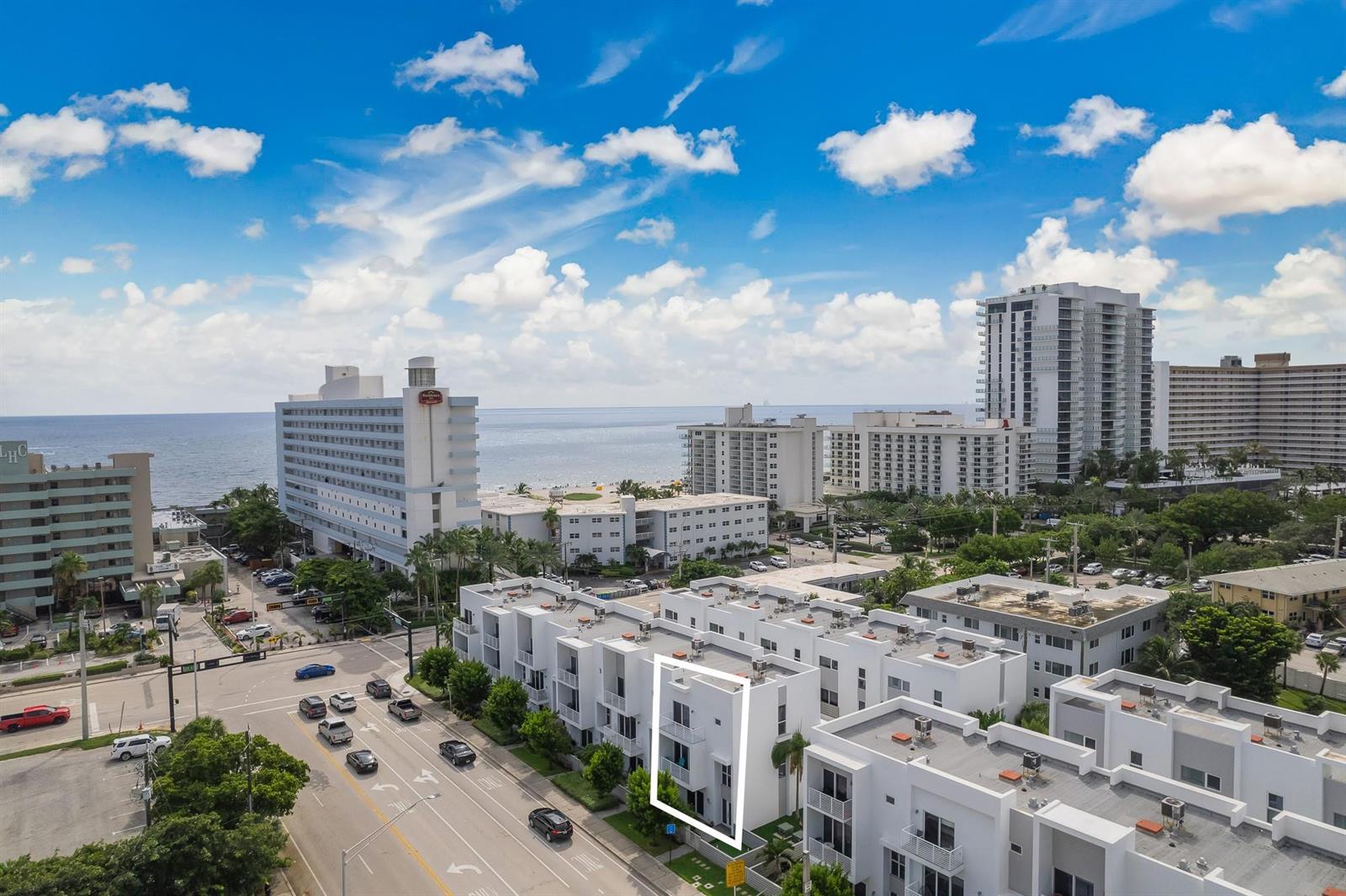 An aerial view shows a modern white townhouse complex near the ocean and city streets — 1371 N Ocean Boulevard, Pompano Beach FL 33062, POMPANO BEACH, FL