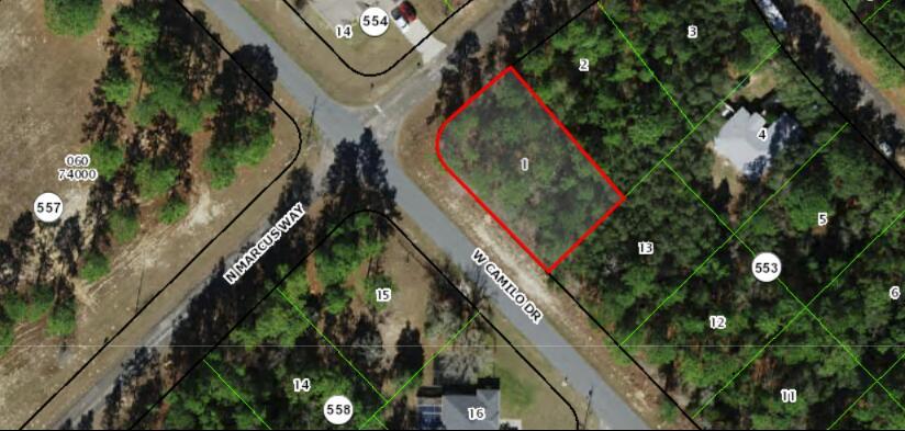 This is an aerial map showing a vacant, wooded lot outlined in red at a street corner — 9239 N Marcus Way, FL 34433, FL