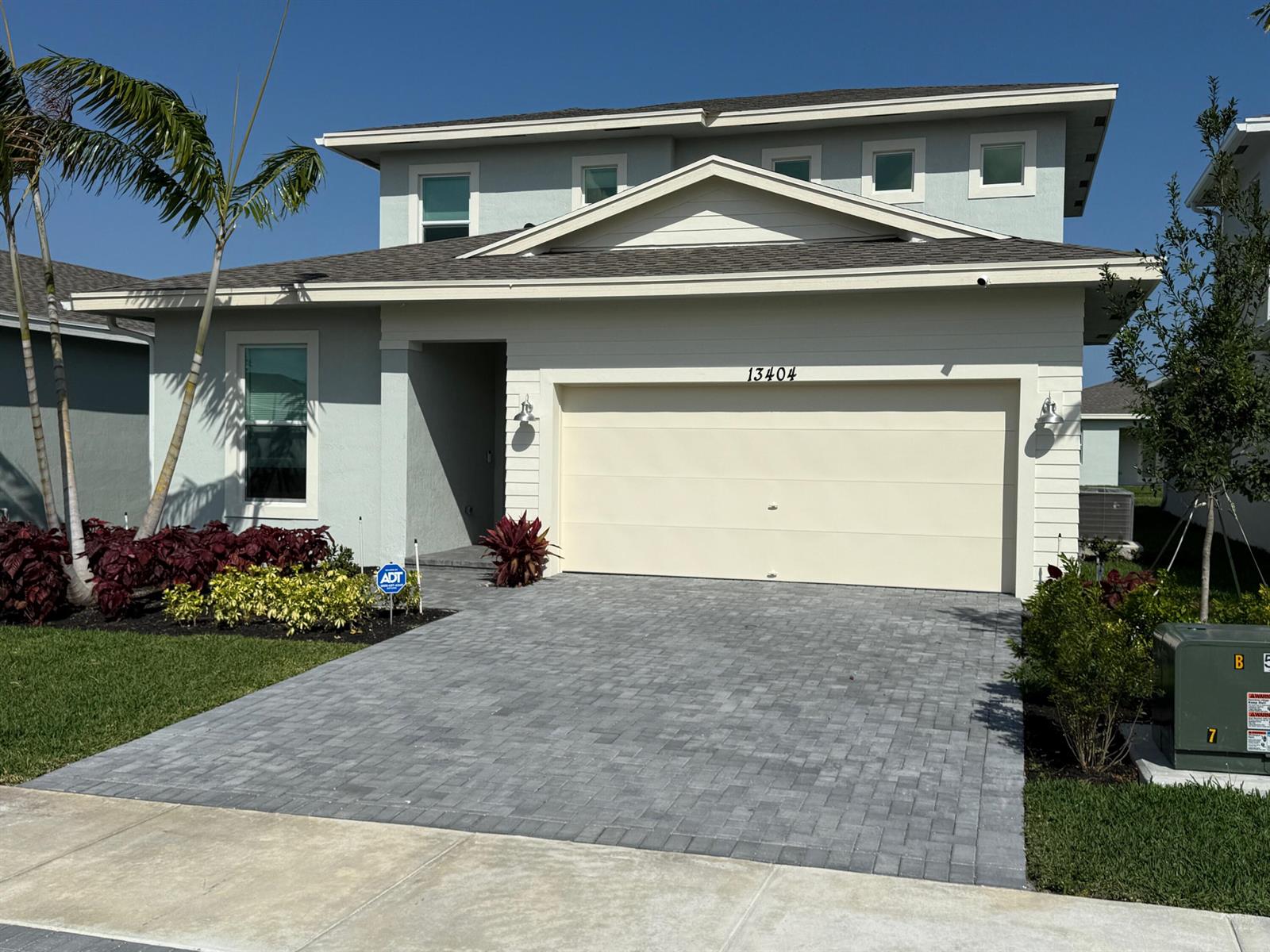 A two-story house with a paved driveway, a two-car garage, and palm trees — 13404 Brotherhood Way, Delray Beach FL 33484, DELRAY BEACH, FL