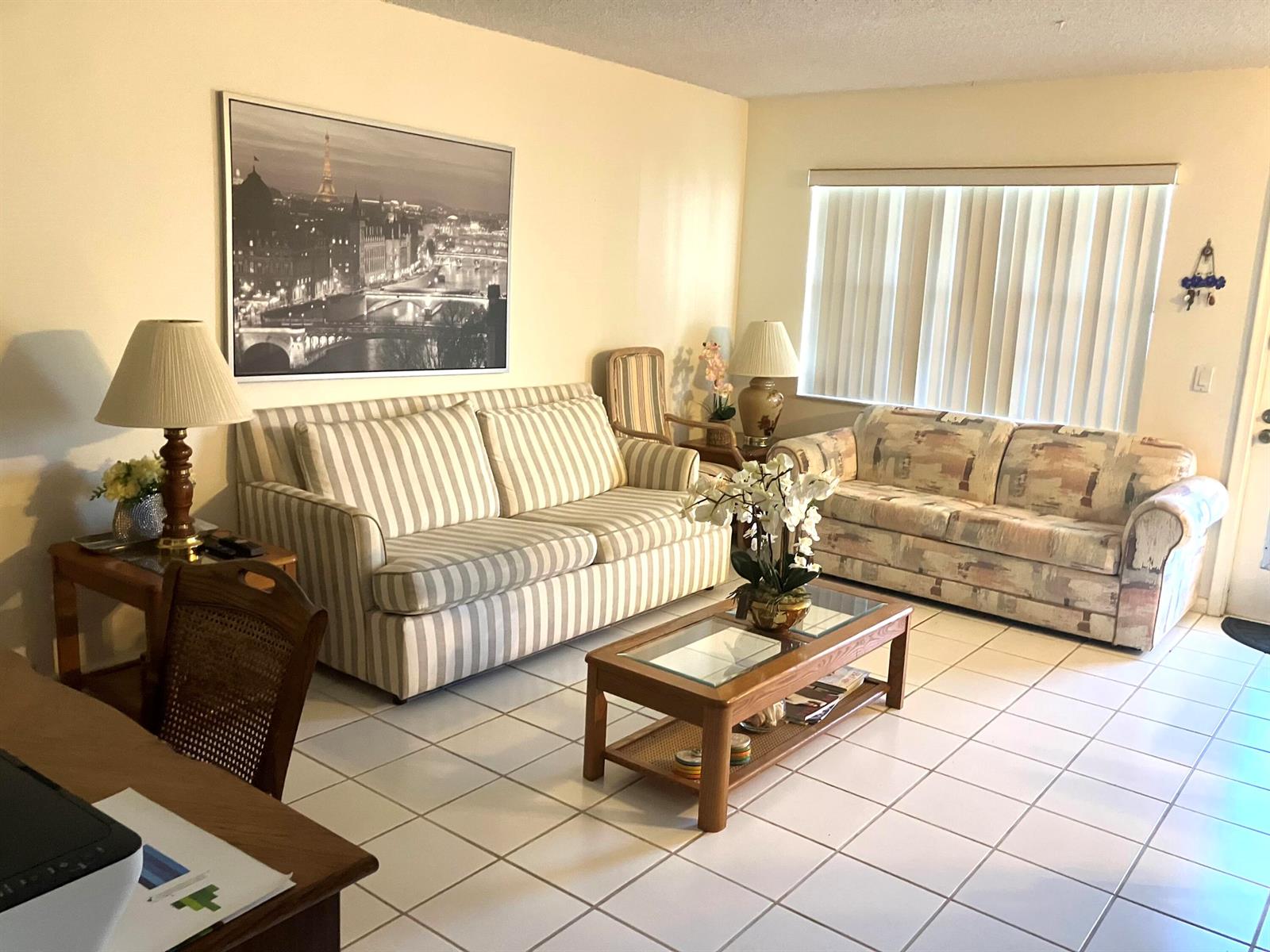 A living room features a striped sofa, a patterned loveseat, tile flooring, and a coffee table — 283 Durham H E # 283, Deerfield Beach FL 33442, DEERFIELD BEACH, FL