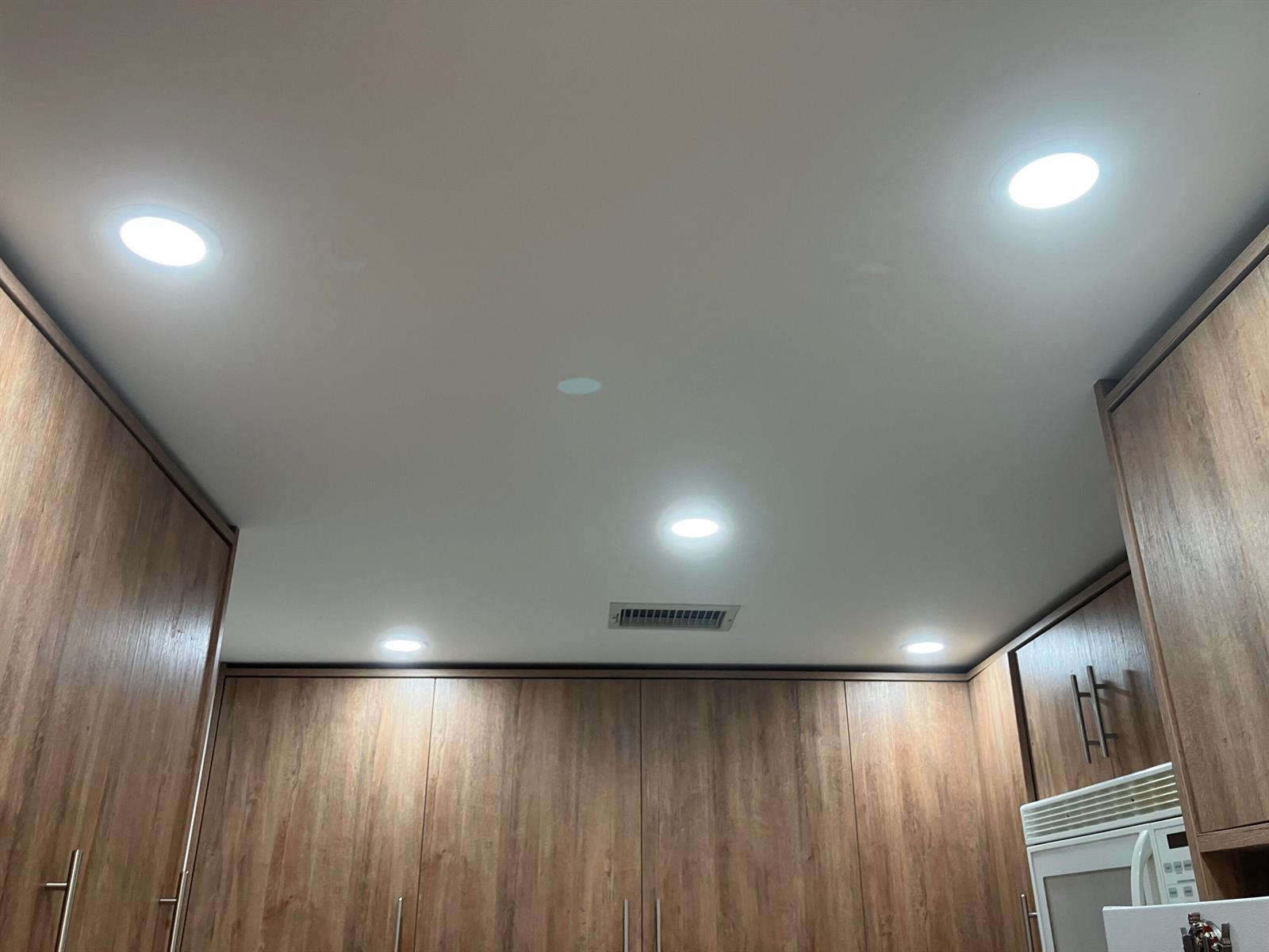 A kitchen ceiling features five recessed lights and a central air vent above wood cabinets — 283 Durham H E # 283, Deerfield Beach FL 33442, DEERFIELD BEACH, FL