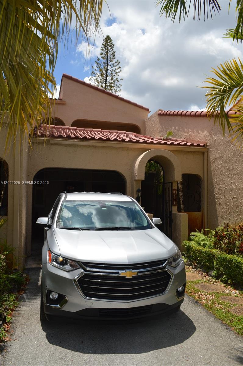A silver Chevrolet SUV is parked in the driveway of a tan stucco house — 3932 Estepona Ave, Doral FL 33178, DORAL, FL