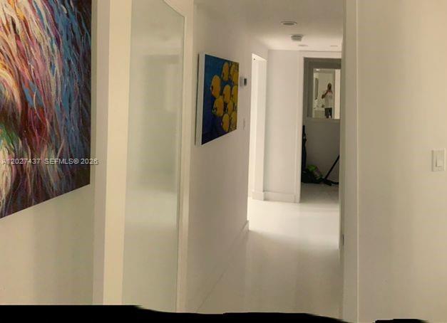 A bright hallway with white floors leads to a doorway with a mirror reflection — 100 Lincoln Rd # 1535, Miami Beach FL 33139, MIAMI BEACH, FL