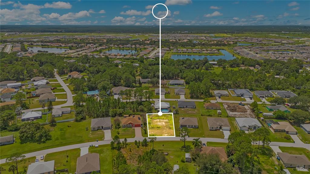 An aerial view shows a vacant residential lot outlined in white within a suburban neighborhood — 1358 TORDIRA STREET SE, PALM BAY, FL
