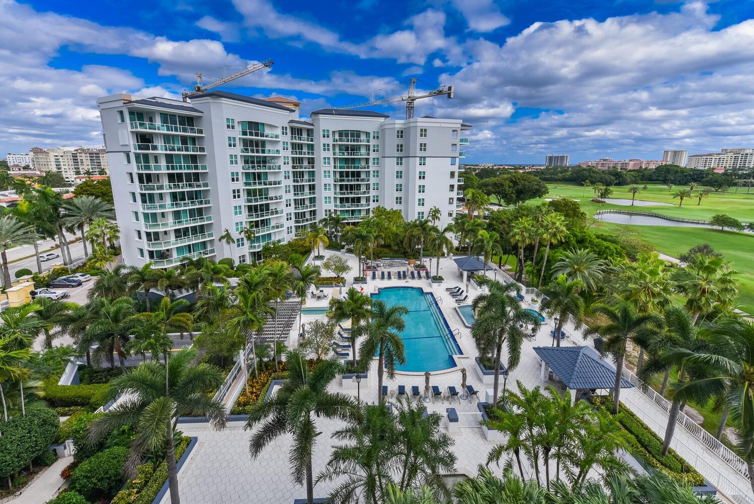 An aerial view of a multi-story apartment building with a swimming pool and golf course — 550 SE Mizner Boulevard # B702, Boca Raton FL 33432, BOCA RATON, FL