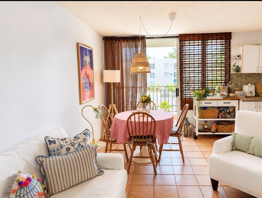 A living and dining area features tile floors, a round table, and a balcony view — PRINCIPAL CASA DEL MAR II UNIT 2705, RIO GRANDE, PR