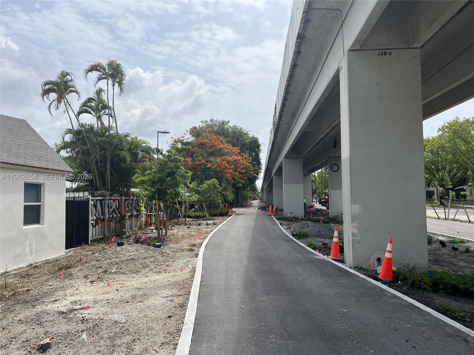 A paved path runs alongside a concrete highway overpass and a residential building — 1866 SW 25th Ter, Miami FL 33133, MIAMI, FL