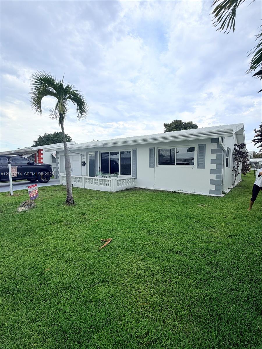 A white single-story house with a palm tree and a lawn in the front yard — 2960 NW 1st Dr, Pompano Beach FL 33064, POMPANO BEACH, FL