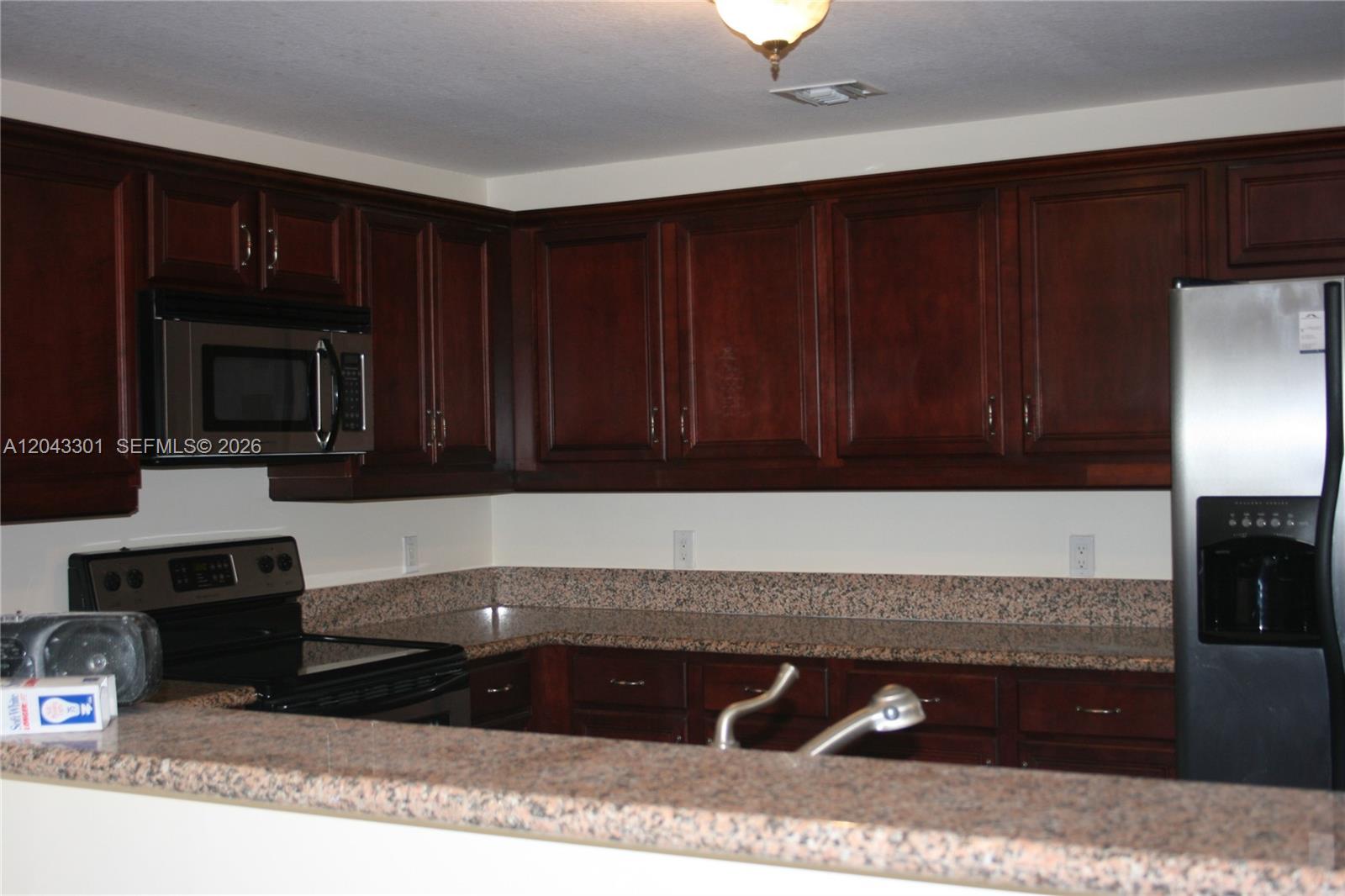 A bathroom features a walk-in shower with glass doors, a toilet, and a vanity — 5271 SW 8th St # 216, Miami FL 33134, MIAMI, FL