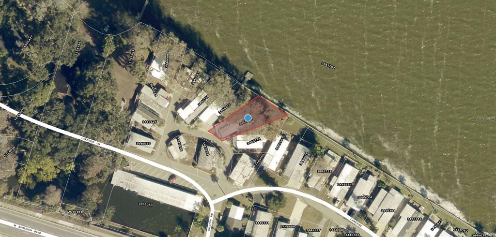 This is an aerial map showing a waterfront property highlighted in red — 12315 US HIGHWAY 441 UNIT 23, TAVARES, FL
