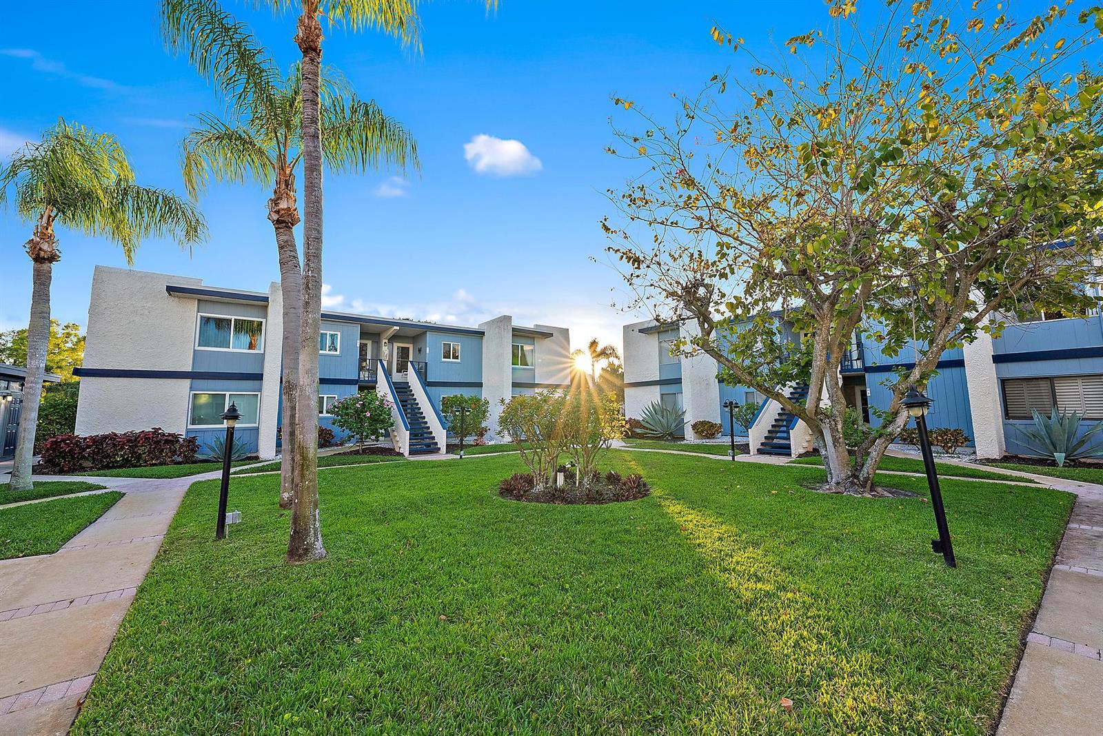 A kitchen with white cabinets, stainless steel appliances, light countertops, and a ceiling fan — 1561 NE 12th Terrace # 14, Jensen Beach FL 34957, JENSEN BEACH, FL