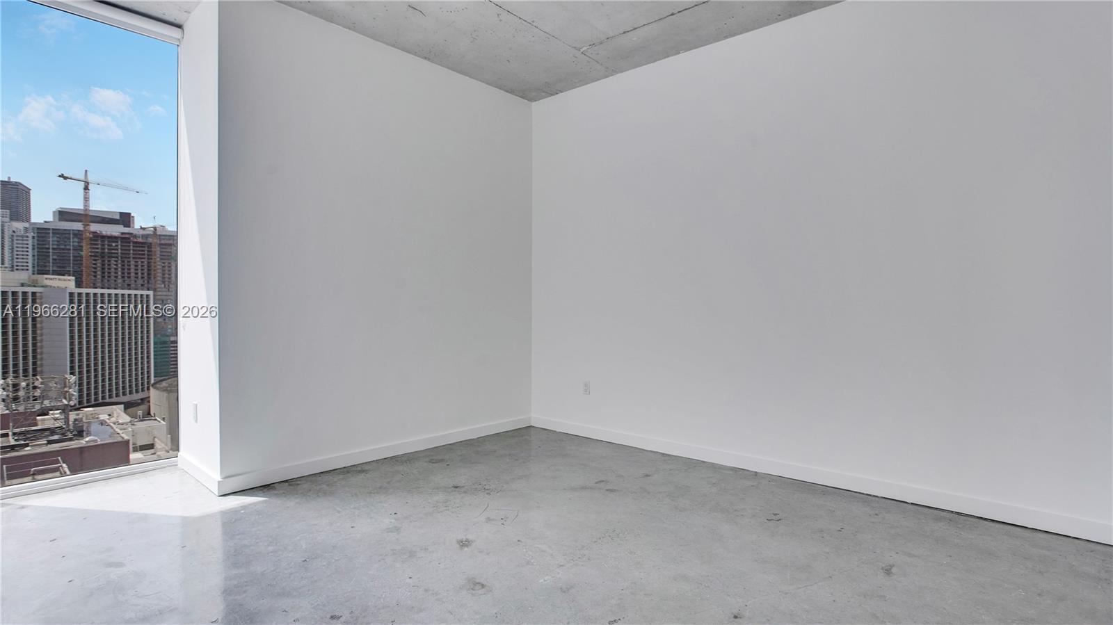 An empty room features white walls, a concrete ceiling, and polished concrete floors — 151 SE 1st St # 2101, Miami FL 33131, MIAMI, FL