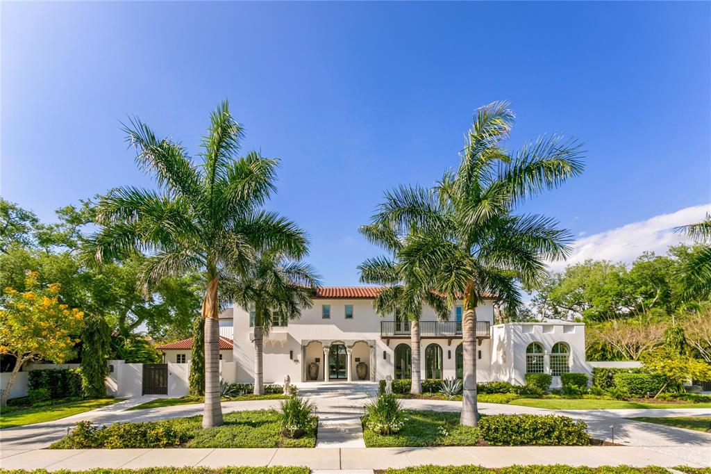 A two-story white stucco house features a tile roof, arched entryways, and two large palm trees — 416 BRIGHTWATERS BOULEVARD NE, ST PETERSBURG, FL
