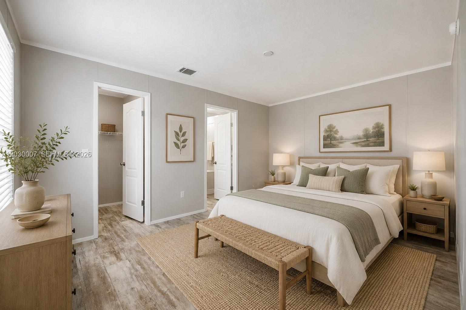 A bedroom features a queen bed, a woven bench, light wood furniture, and neutral walls — 5530 SW 32nd Ter, Dania Beach FL 33312, DANIA BEACH, FL