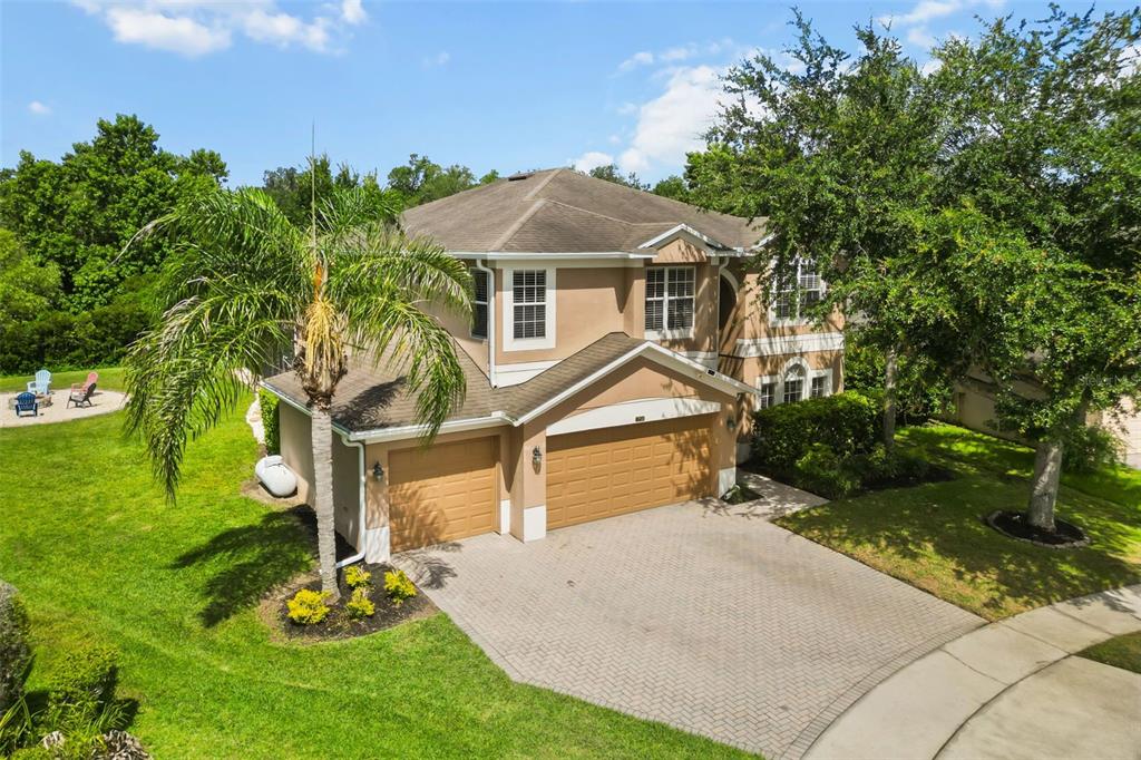 An aerial view shows a two-story house with a three-car garage and a paved driveway — 1732 BILLIE LYNN POINT, SANFORD, FL