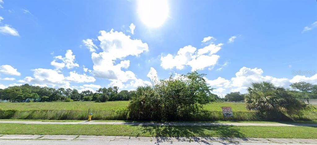 A vacant, grassy lot with a fence, a fire hydrant, and a for sale sign — 1 ARMAND DRIVE, TAMPA, FL
