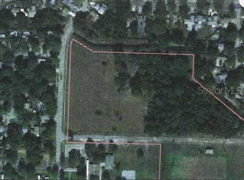 An aerial view shows a vacant, partially wooded lot outlined in red — 1 ARMAND DRIVE, TAMPA, FL