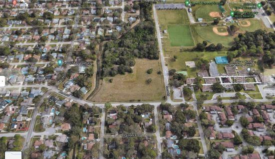 This is an aerial map view of a vacant lot surrounded by residential homes and fields — 1 ARMAND DRIVE, TAMPA, FL