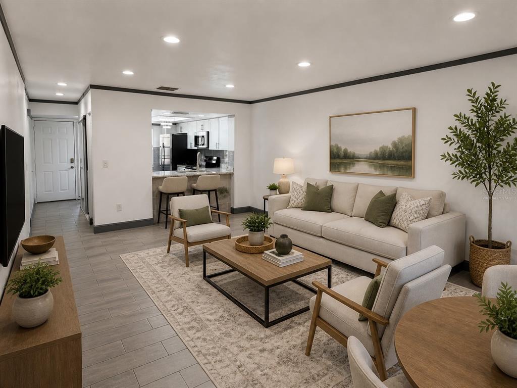 A living room with a sofa, two armchairs, a coffee table, and an open kitchen — 2275 62ND AVENUE N UNIT 5202, ST PETERSBURG, FL