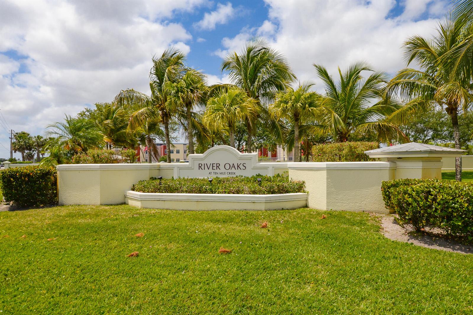 A beige community entrance sign for River Oaks at Ten Mile Creek with palm trees — 3904 Sabal Way, Fort Pierce FL 34981, FORT PIERCE, FL